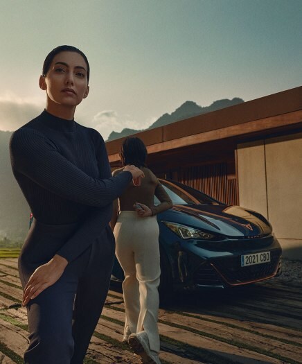 Girls standing next to CUPRA Born